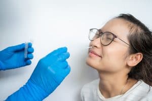 Close-up of woman receiving nasal swab for COVID testing