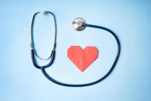 Picture of a stethoscope and a red paper heart.