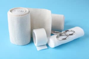 Picture of gauze, medical tape, and scissors.